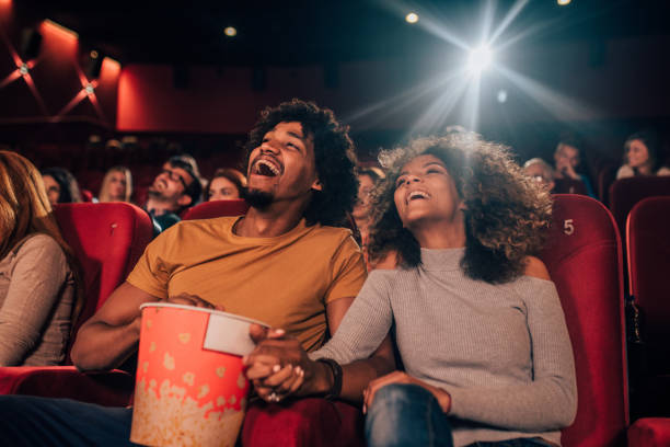 istock Young couple holding hands at cinema 1052507046
