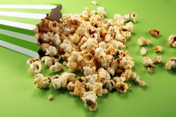 istock Cinema concept with popcorn in green white bag. 1052510194