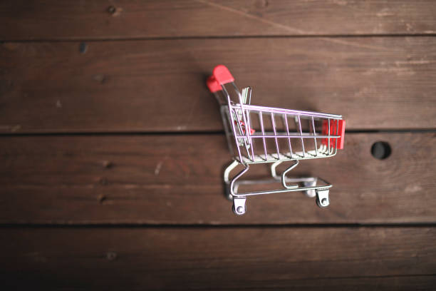 istock Shopping cart on the wooden table 1052525428