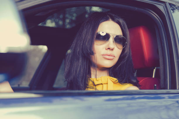 istock Gorgeous woman driving a luxury car 1052539048