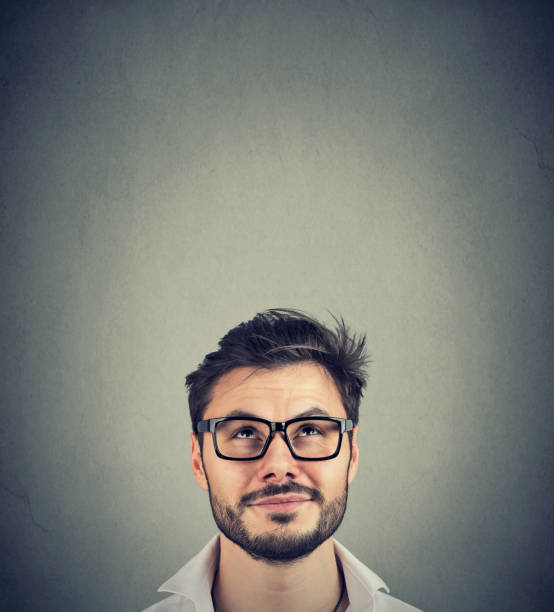 istock Happy man smiling and looking up 1052539444