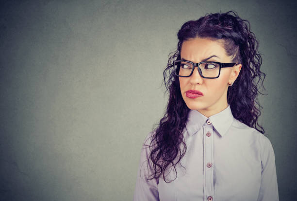 istock Jealous and suspicious woman looking away 1052542388
