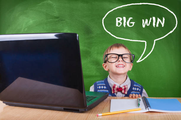 istock Child with laptop peeking in the classroom 1052548508