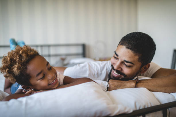 istock Father and daughter lying in bed in the morning 1052570832