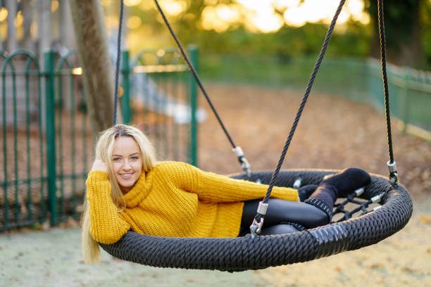 istock Beautiful woman swinging 1052607262