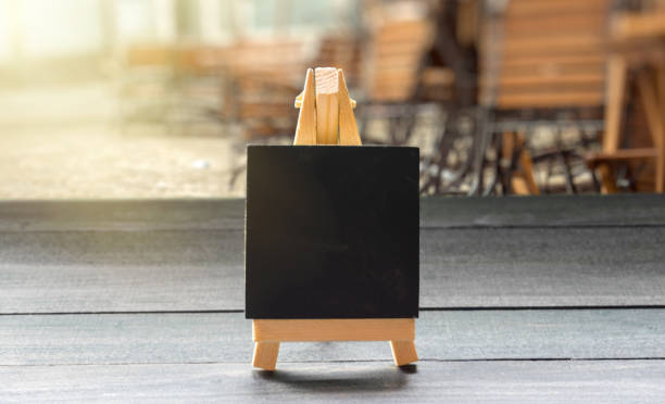 istock Mini chalkboard on wooden table at restaurant 1052609902