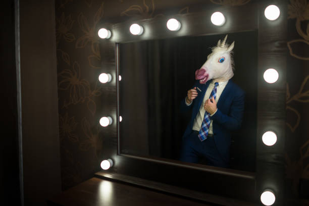 istock Glamour guy in elegant suit and comical mask 1052664246