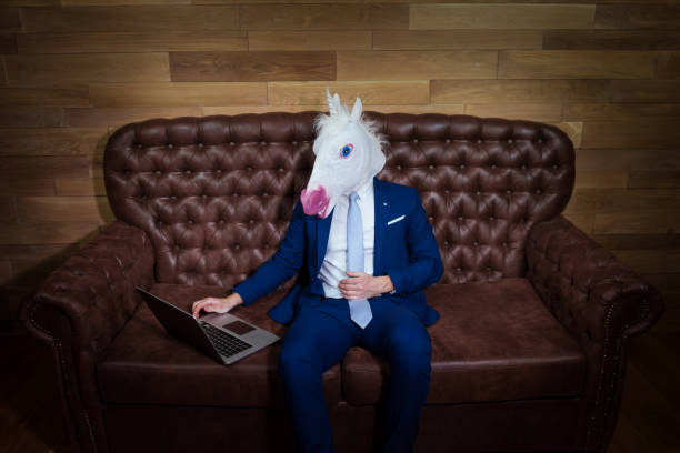 istock Strange man in elegant suit working at home office 1052664844