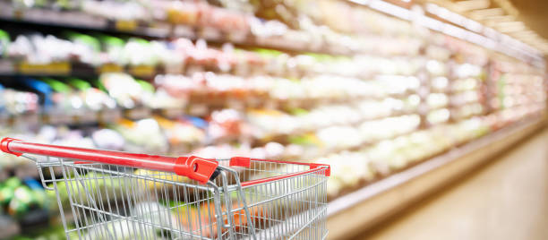 istock supermarket grocery store with fruit and vegetable shelves interior defocused background with empty red shopping cart 1052673414