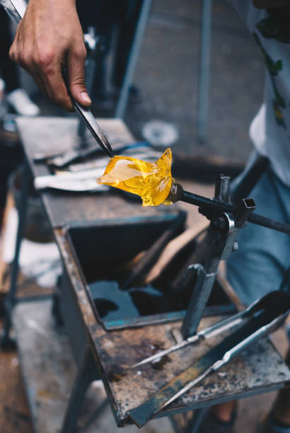 istock Glass blowing craft shop. Worker`s hands with tools image. Masterpiece creation moment 1052685258