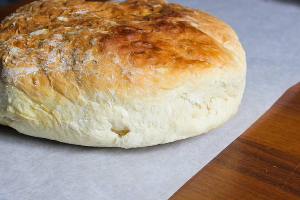 istock Round homemade loaf of bread on a table 1052741776
