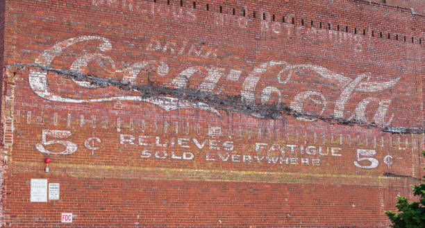 Old Coca-cola sign on building Johnson City, TN, USA-9/30/18: An old coca-cola sign on the side of an old brick building, advising that it "relieves fatigue". relieves stock pictures, royalty-free photos & images