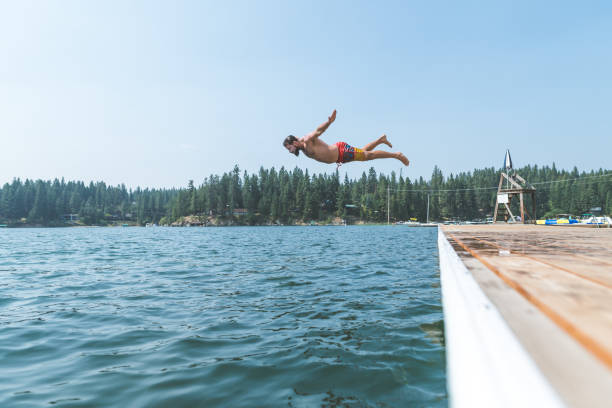 istock Young man dives into a pristine lake 1052790558