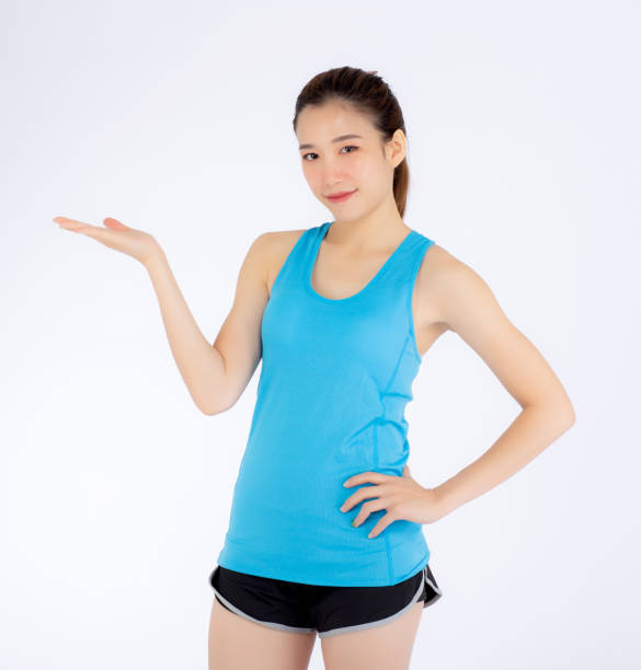 istock Beautiful portrait young asian woman standing presenting something empty copy space on the hand isolated on white background, girl wear sport clothes exercise for health, wellness concept. 1052790598