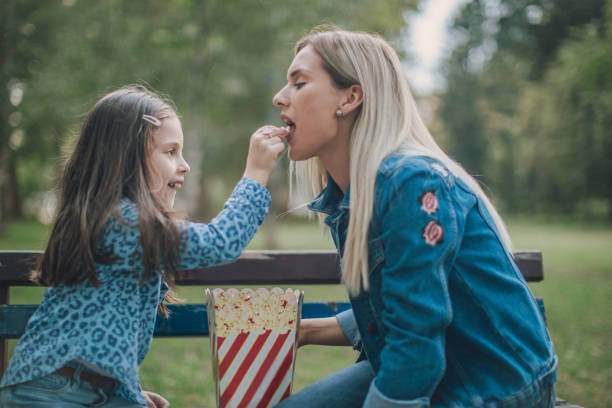 istock Family eating popcorn in park 1052818212