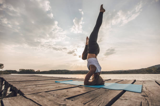 istock Yoga headstand by the lake 1052872904