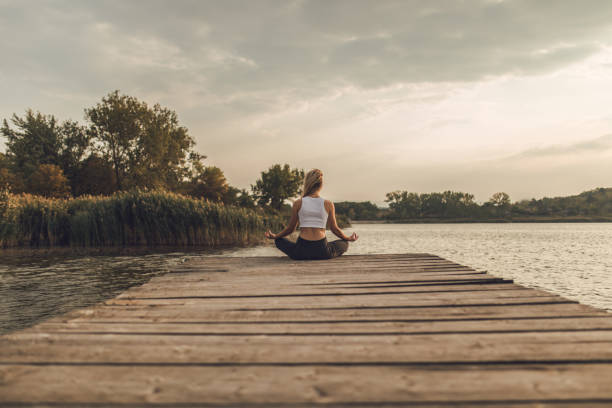 istock Girl meditating in nature 1052876250