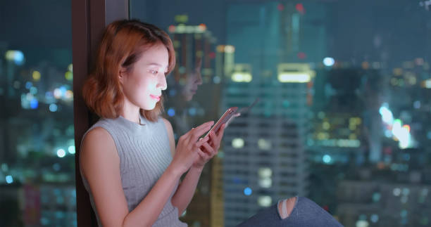 istock woman use phone happily 1052876466
