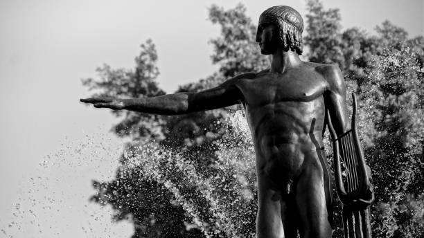 Men pointing right standing on a fountain
