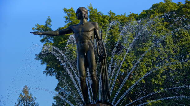 istock Men pointing right standing on a fountain 1052876668