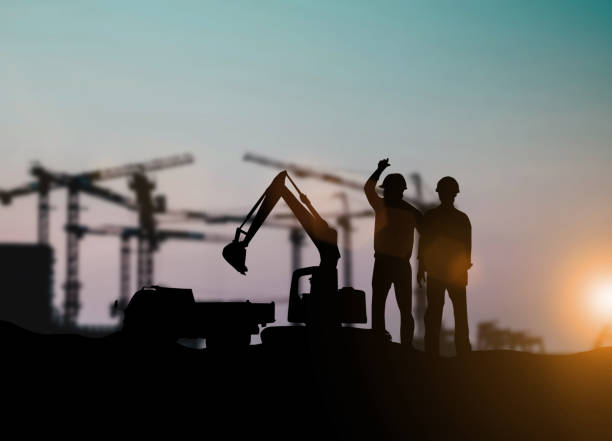istock Silhouette of engineer and construction team working at site over blurred background for industry background with Light fair.Create from multiple reference images together 1052879964