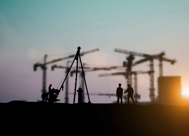 istock Silhouette of engineer and construction team working at site over blurred background for industry background with Light fair.Create from multiple reference images together 1052879966