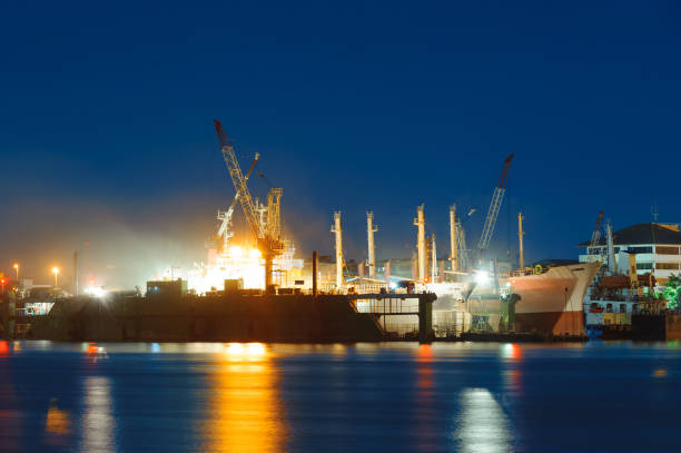 istock Cargo ship under repair in floating dry dock at night 1052881508