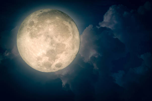 istock Surreal fantasy full moon on cloudy night sky 1052881896
