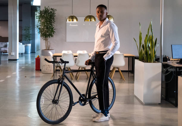 istock Young african entrepreneur standing with his commuter bike 1052888662