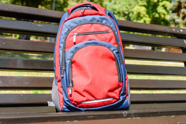 istock Tourist backpack on a bench in city park 1052890176