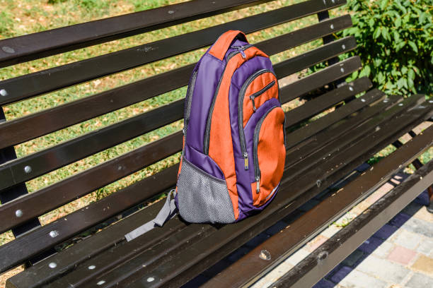 istock Tourist backpack on a bench in city park 1052890186