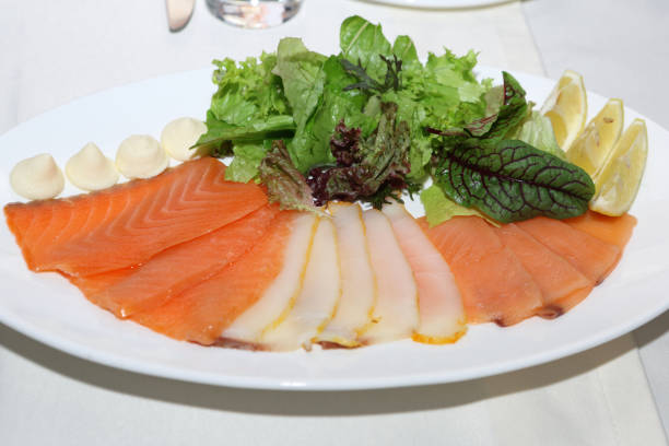 Slicing fillets of different types of fish on a plate