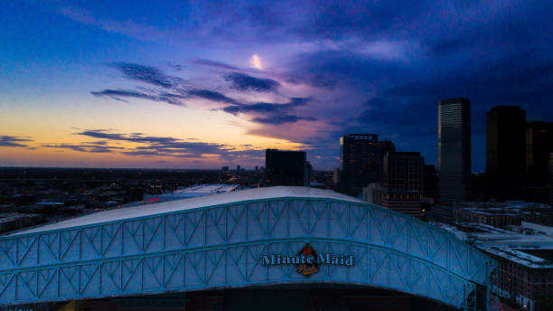 Aerial View of Minute Maid Park Roof during Sunset Houston, Texas, United States - October 9, 2018, Tuesday: This photo is of a aerial view of Minute Maid Park retractable roof during a sunset behind Houston's skyline. texans stadium stock pictures, royalty-free photos & images