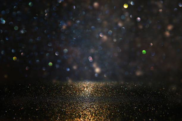 istock glitter vintage lights background. black and gold. de-focused. 1052896978
