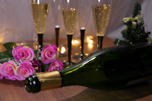 istock Champagne and bottle, roses and Christmas tree 1052898962