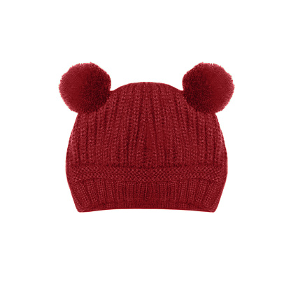 Red knitted baby hat with funny ears bear isolated on white background
