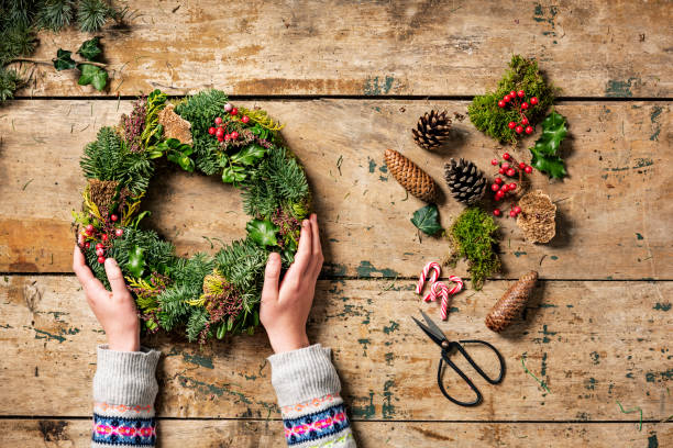 istock Overhead view of Christmas wreaths being made. 1052906554