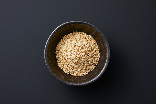 Top view of a wooden spoon with grain millet and other mixed grains on it
