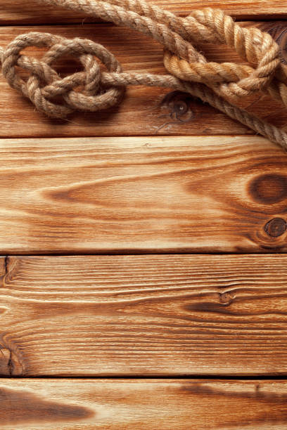 istock ship rope at wooden background 1052922730