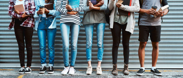 At the starting line to a bright future Shot of a group of unrecognizable university students standing together outside at campus unidentifiable persons stock pictures, royalty-free photos & images