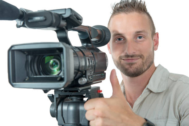 istock cameraman with professional camcorder make OK sign isolated on white background 1052929598