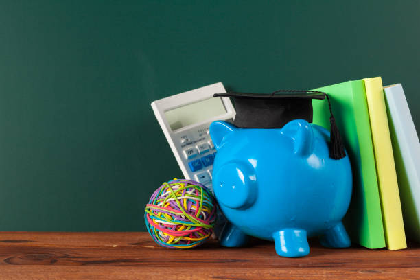 istock Piggy bank on blackboard background. 1052933906