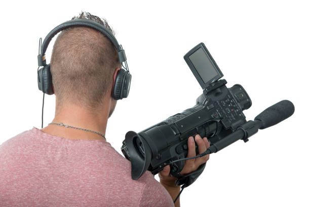 istock cameraman with professional camcorder and headphones, a back view 1052934516