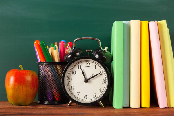 istock back to school - apple and books with pencils and blackboard 1052934964