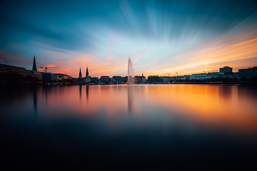 Panoramic view of Binnenalster, Inner Alster Lake in golden and blue evening light at sunset, Hamburg, Germany. Blue hour. Long exposure