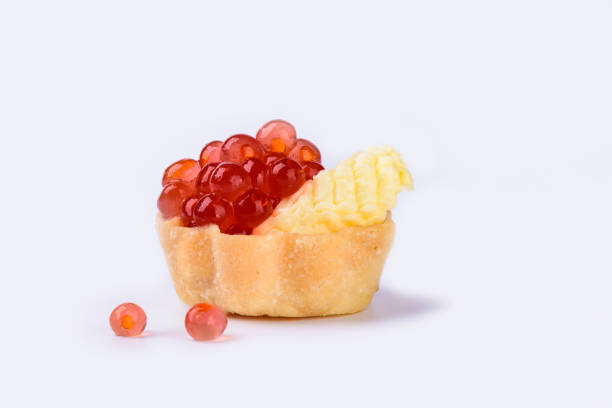 istock Tartlet with red caviar and butter isolated on white background 1052937112