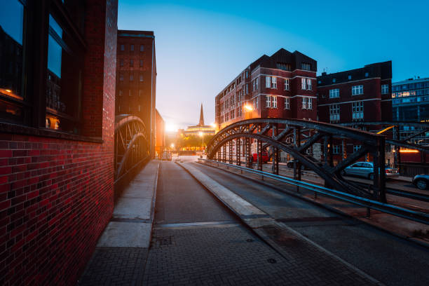 istock Empty Poggenmuehlen Bridge at twilight. Hamburg, Germany. illuminated buildings and last sunrays. Warehouse District -Speicherstadt Landmark of HafenCity quarter. Most visited touristic famous place 1052937584