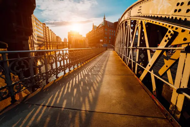 Bridge Arch with rivets in the Speicherstadt of Hamburg during sunset golden hour with sunset light.