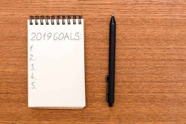 istock Notebook for recording purposes for 2019 on wooden desk 1052940352
