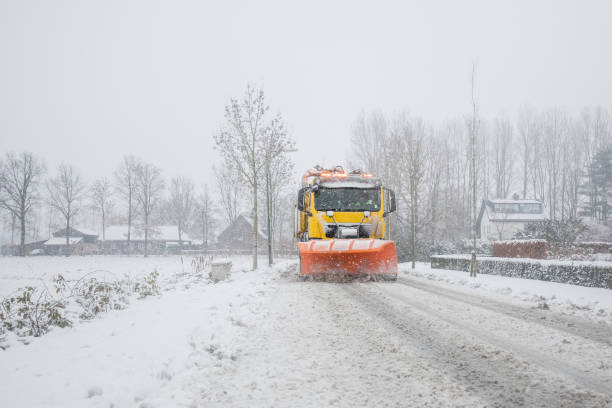 istock snowplow clearing road, winter service 1052940506